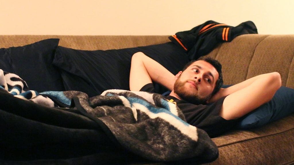 Rudolph Tescallo, senior psychology major, lies on the couch he will be sleeping on for the night at his friend’s house at Westlake Village Apartments in Daly City Wednesday, Sept. 23. (Screen Shot Jocelyn Carranza / Xpress) 