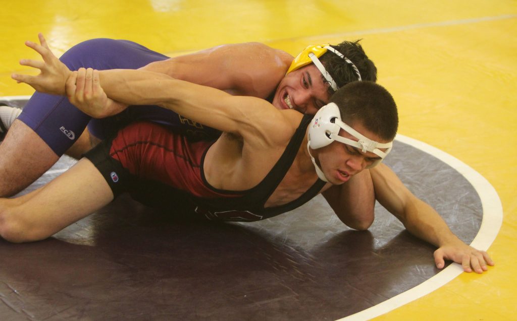 Romeo Medina (SF State)  and Naino Calvo (Stanford) wrestle in the first round of the 157 pound division at the 48th Annual San Francisco State University Community College/College Open, Sun Nov 1 at the Swamp at SF State. (James Chan/Xpress)