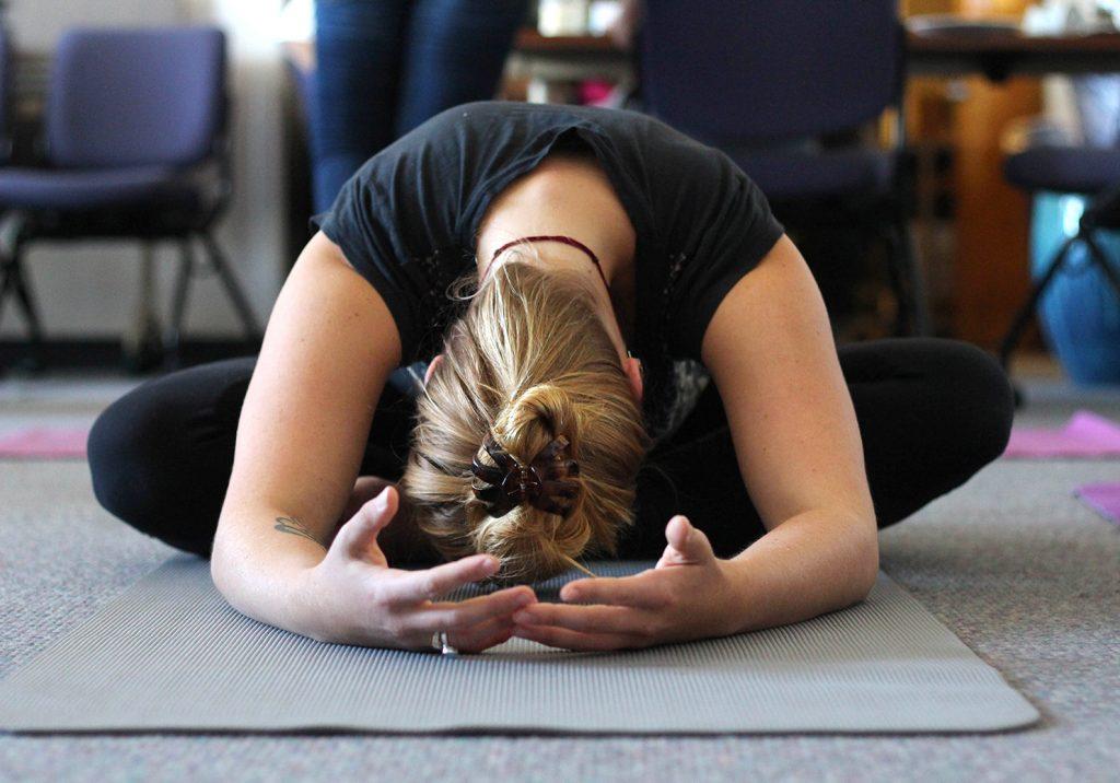 Kelsie Gray, a student and yoga instructor at the holistic health center, practices a pose during the free massage and yoga lessons day every Wednesdays from 10 a.m. to 12:30 p.m. Wednesday, Nov. 4, 2015. (Alex Kofman / Xpress)
