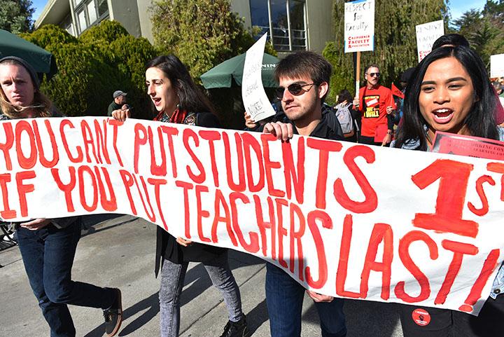 Students march on the side walk of 19th Avenue for supporting faculty members who participated in the protest organized by CFA at SF State Tuesday, Nov.17, 2015. (Qing Huang / Xpress)