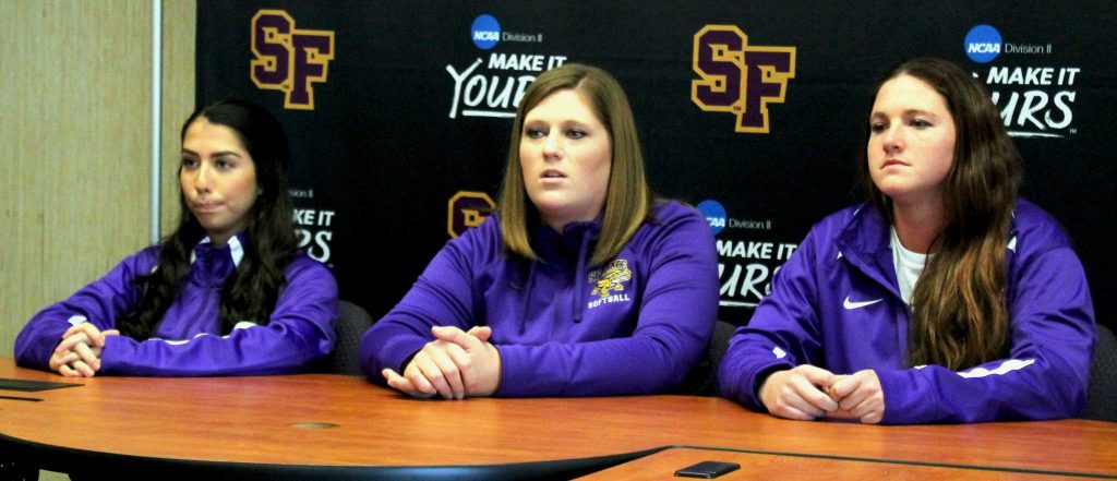 SF State head softball coach Lisa Allen, center, answers Media Day questions with outfielder/pitcher Aryn Guzman, left, and starting pitcher Megan Clark. (Pablo Caballero / Xpress)