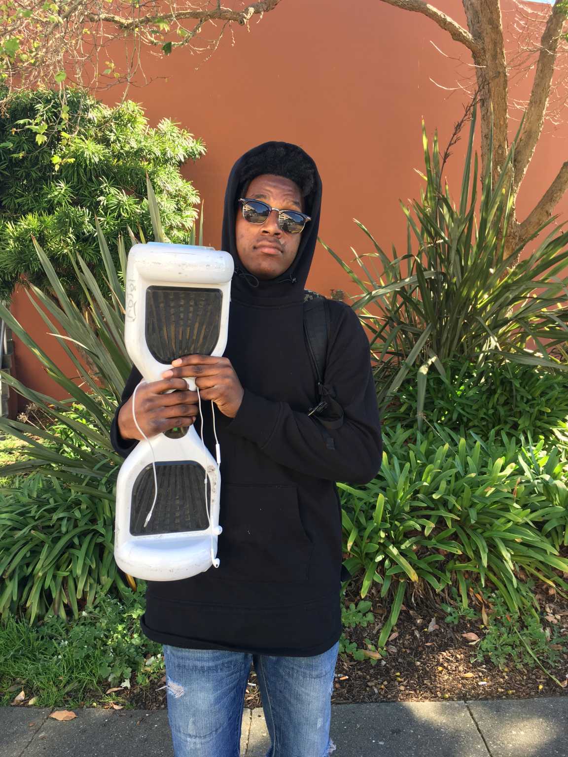 Donald Howard, an 18-year-old kinesiology major, poses with his hoverboard at SF State on Monday, Feb. 15. 