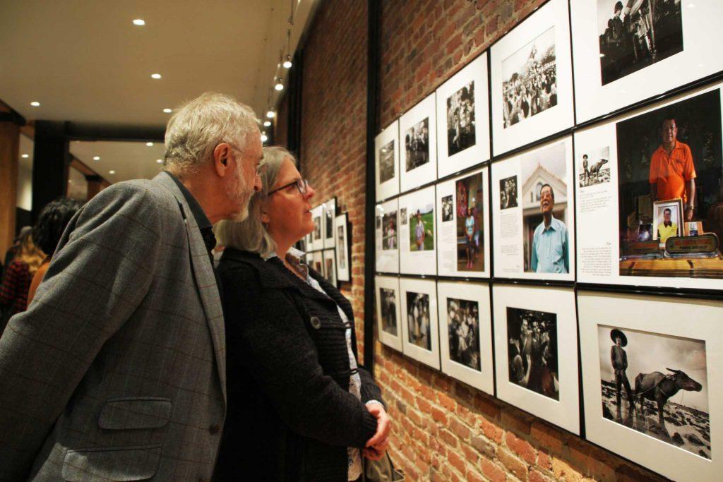Harry Mathias and Anne Morkill view Kim Komenichs photographs at his Revolution Revisited exhibit at the Leica Store San Francisco, Tuesday, Feb. 23, 2016. (Mira Laing / Special to Xpress)