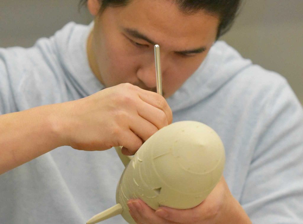 Studio art major Nick Oh works in the ceramics studio in the Fine Arts Building Tuesday, Feb. 2. (Qing Huang / Xpress)