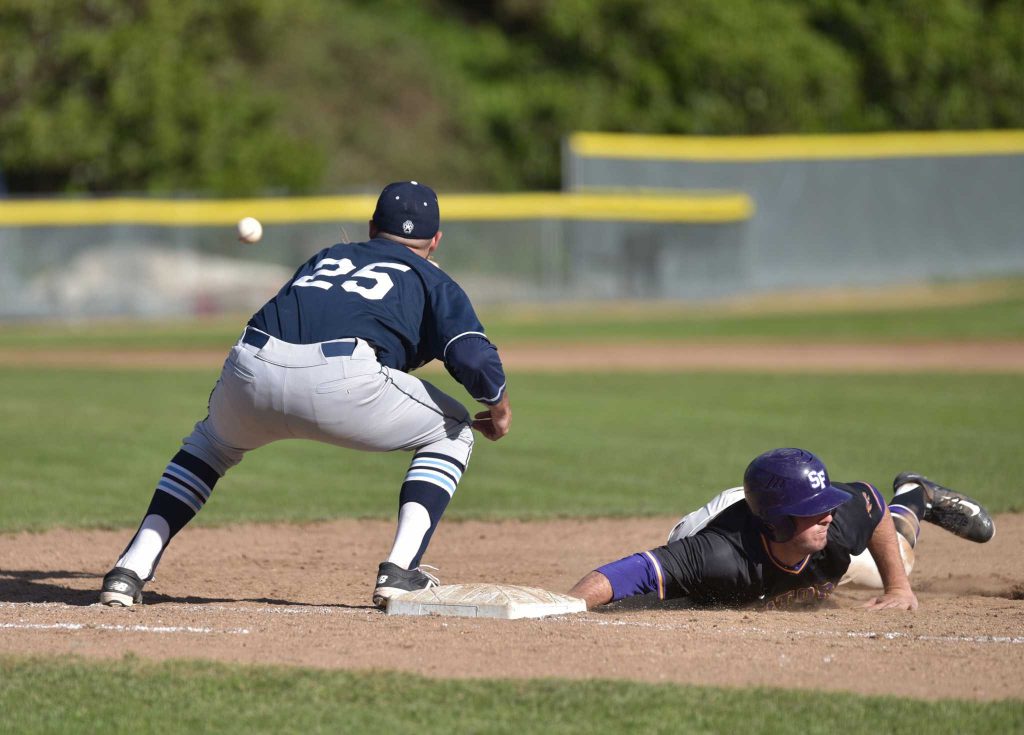  SF State Gators third baseman Connor Fraser (13) slides safely back to first base against Sonoma State Seawolves first baseman Tyler Glenn (25) in Gators 6-1 win at Maloney Field in SF State Tuesday, Feb.23. (Qing Huang / Xpress)