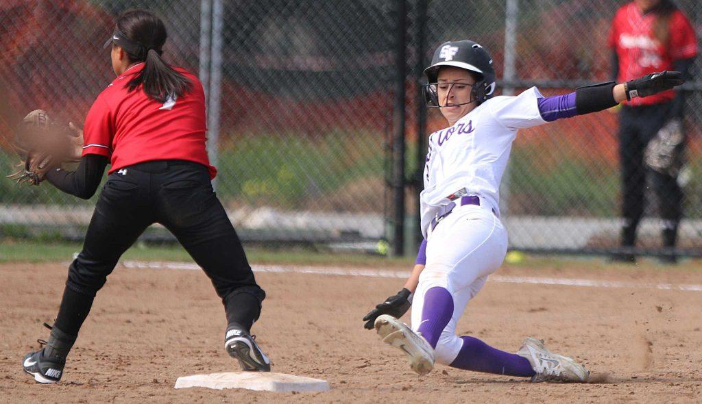 SF State Gators outfielder Alexis Mattos (8) slides safely into second base while Warriors infielder Alexus Martinez (7) waits for the ball during their 4-0 loss to Cal State Stanislaus at SF State on Friday, March 19, 2016. (George Mornin/Xpress)