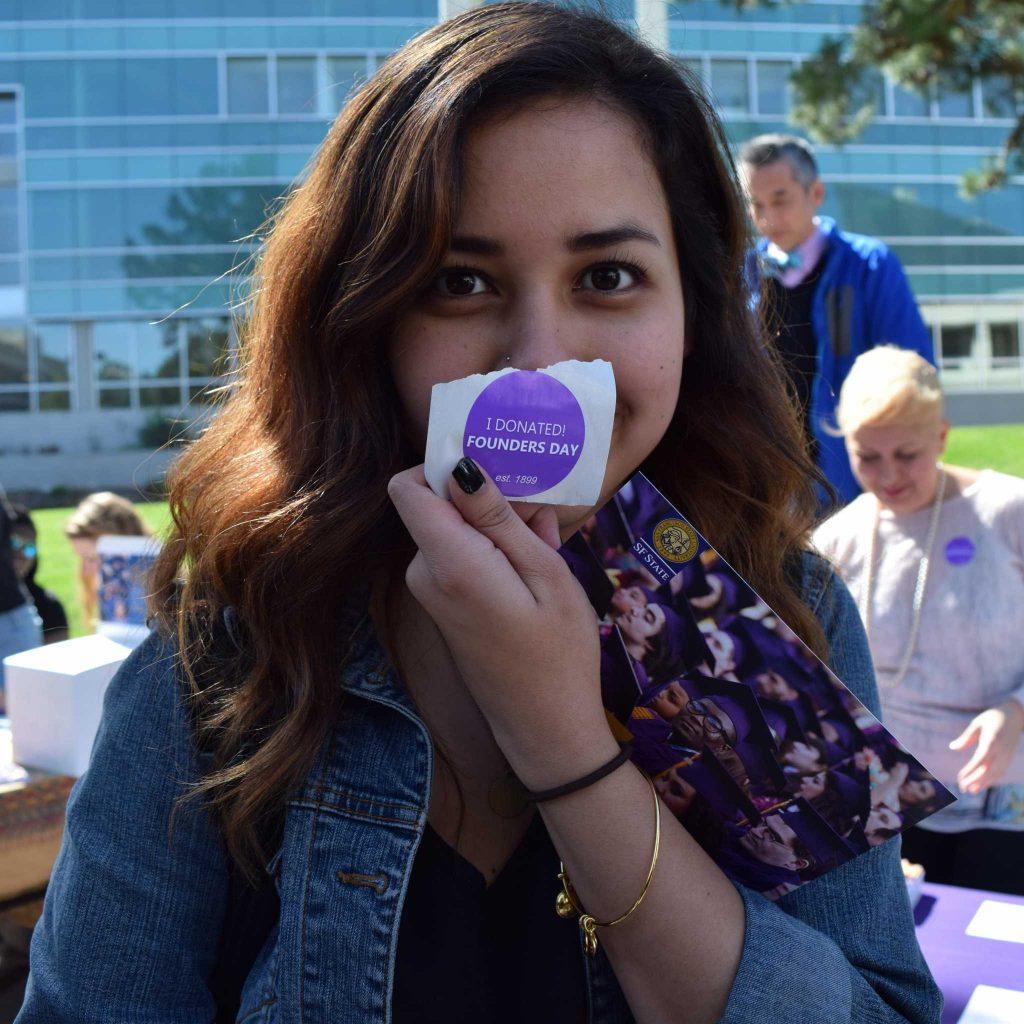 SF State junior Delana Ha donated to the Hope fund at the Alumni Association table at the Founders Day Celebration Tues Mar. 15, 2016. (Gabriela Rodriguez / Xpress)