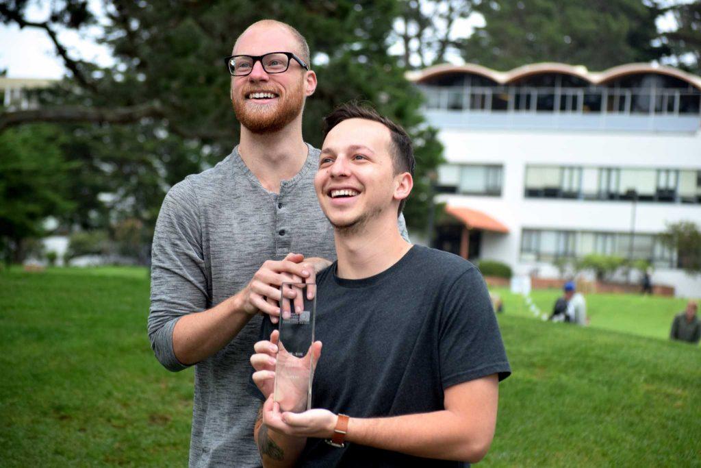 Eric Renard (left) and Brandon Lopez (right) pose for a portrait with their first place trophy from the Stanford Design Challenge. (Eric Chan / Xpress)