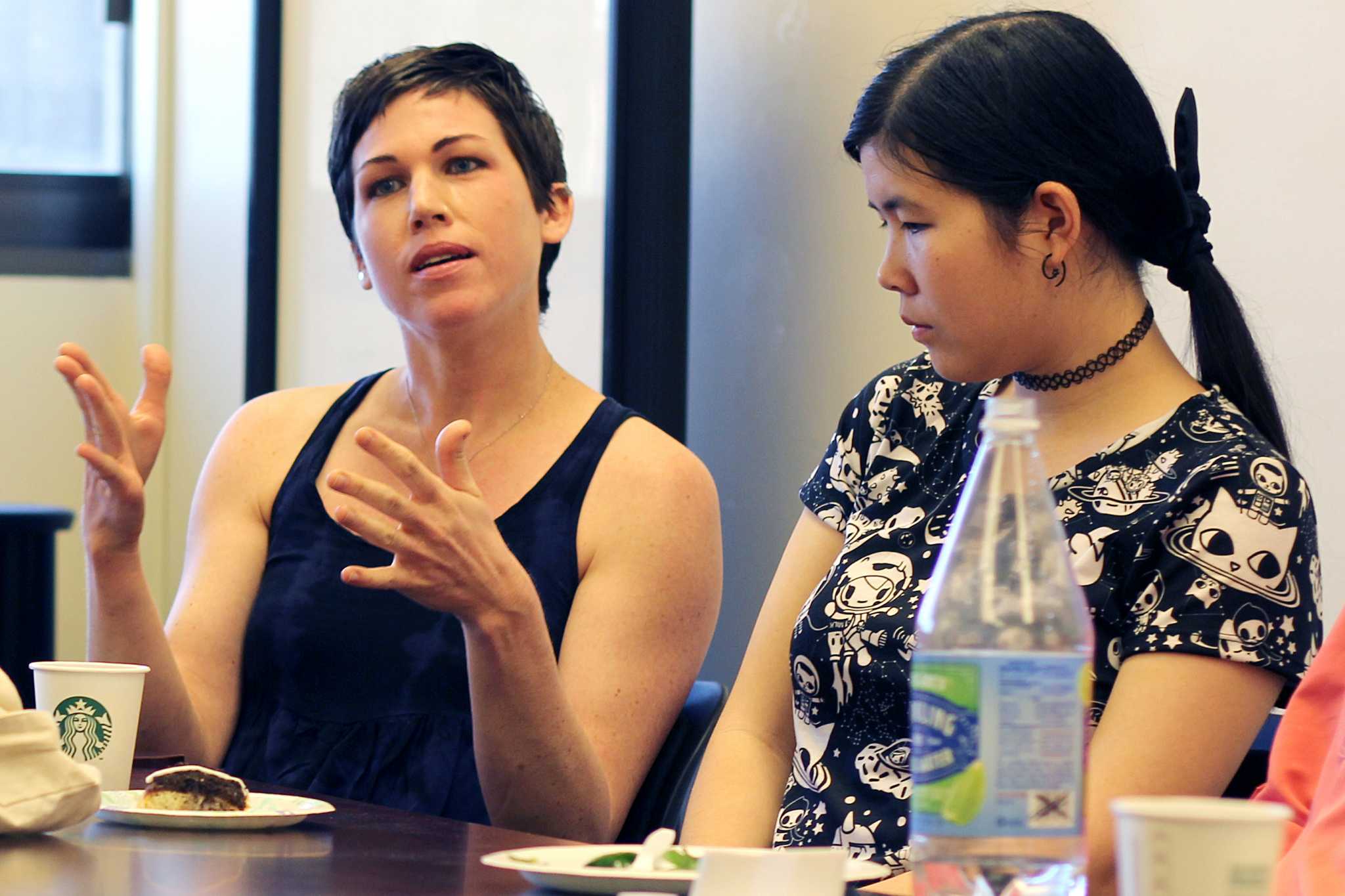 Astrophysics majors Wendy Crumrine (left) and Audrey Dijeau (right) engage in a discussion about their love for physics with award-winning planetary scientist Dr. Carolyn Porco during their Women in Physics and Astronomy club meeting in Thornton Hall 434 at SF State on Monday, April 18, 2016. (George Morin / Xpress)