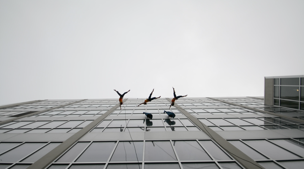 Aerial dancers suspended five stories above the ground during their performance at SF State on May 3, 2016. (Screen shot by: Ryan Zaragoza / Xpress)