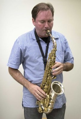 Andrew Speight, an SF State music and dance lecturer, plays saxophone in his office in the Creative Arts building on Tuesday, Aug. 30, 2016.