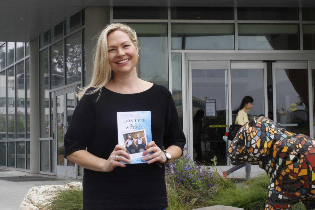 Author Michelle Kennedy poses with her book outside the library on Thursday, Sept. 8, 2016. 