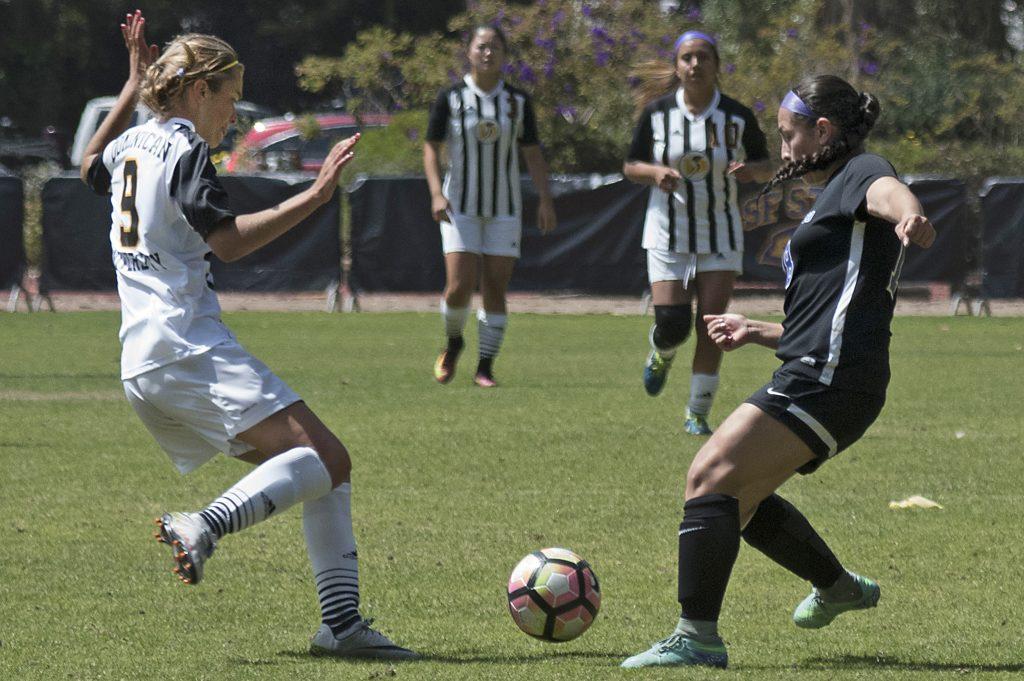 SF State Gators freshman defender Valentina Riveros (18) prepares to clear the ball during their 2-2 double overtime tie against Dominican University of California at Cox Stadium on Sunday, Sept. 4, 2016.
