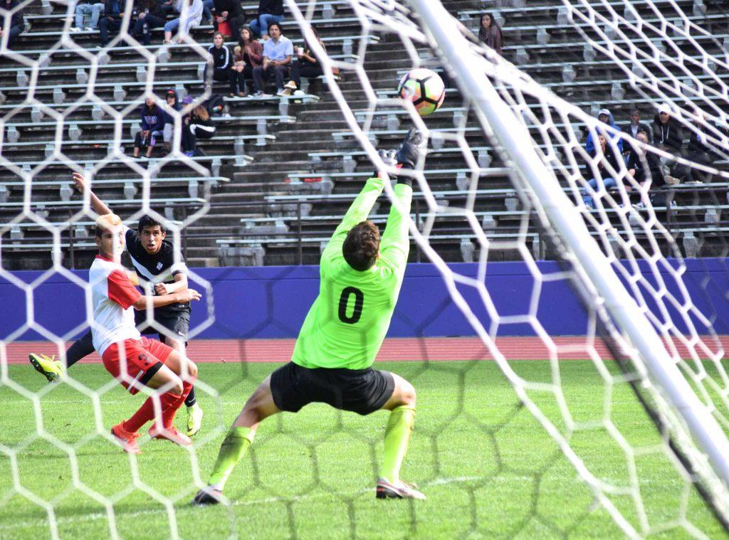 SF State freshman forward Richard Leon (8) boots a ball past the Stanislaus State’s Warrior goalkeeper during their 2-0 win over the Warriors at Cox Stadium on Saturday, Oct. 29, 2016. Leon’s kick hit the top of the goal post and would have been the third goal of the match.
