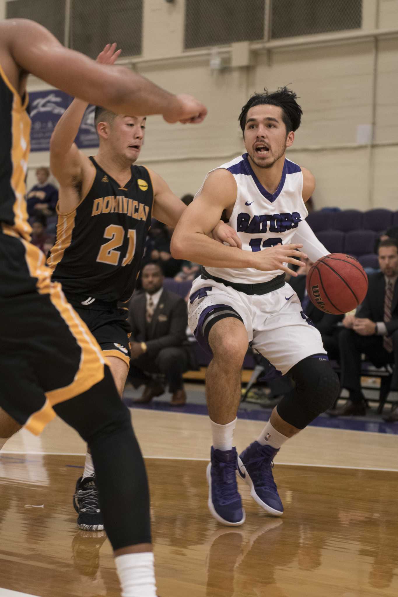 SF State Gators graduate student guard Parker Uu (13) dribbles toward the Dominican Penguins basket during the Gators 91-67 win against the Penguins at the Swamp on Saturday, Nov. 12, 2016. (Kin Lee/Xpress)