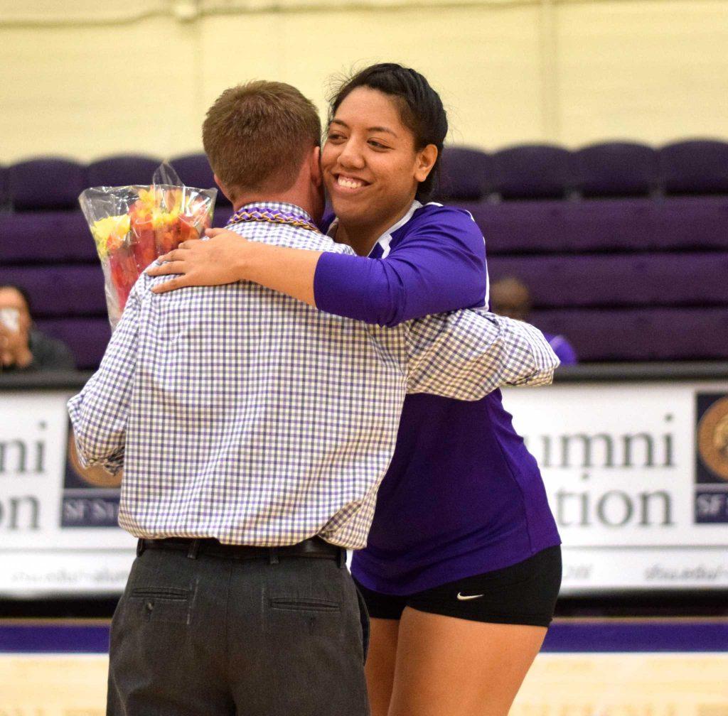 SF State Gators’ senior setter Malia Muin (14) hugs head coach Matt Hoffman during the Senior Day celebrations before their game against Humboldt State University at the Swamp on Friday, Nov. 4, 2016. (Eric Chan/Xpress)