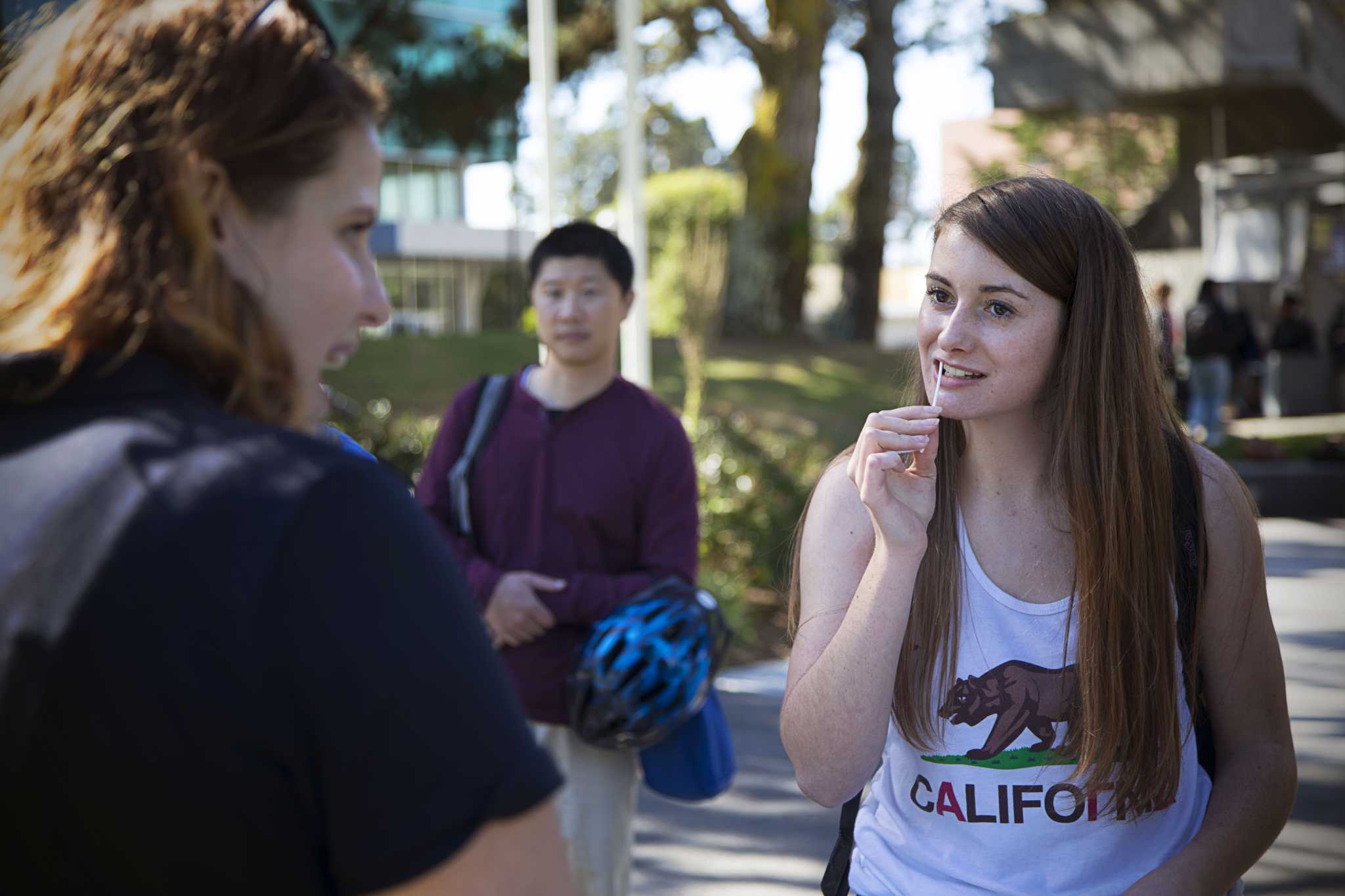 SF State pre-kinesiology major Sophomore Mackenzie Morley swabs her cheek to test if she is a potential bone marrow donor during the Hope 4 Adam bone marrow drive held at the Quad on Wednesday, Oct. 26, 2016. The event was hosted by SF State student Stephanie Levy.