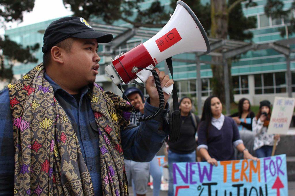 SF State political science major Pat Racello speaks to the students through a megaphone about the 5 percent tuition increase in Malcolm X Plaza on Tuesday, Nov. 15, 2016.