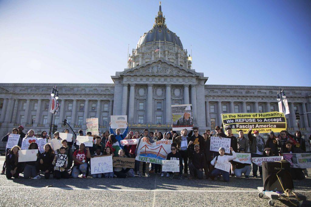 Students and educators pose for a photo in front of City Hall at Civic Center Plaza during a march/walkout calling attention to issues facing students on Friday, Dec. 16, 2016. (Steven Ho/Xpress)
