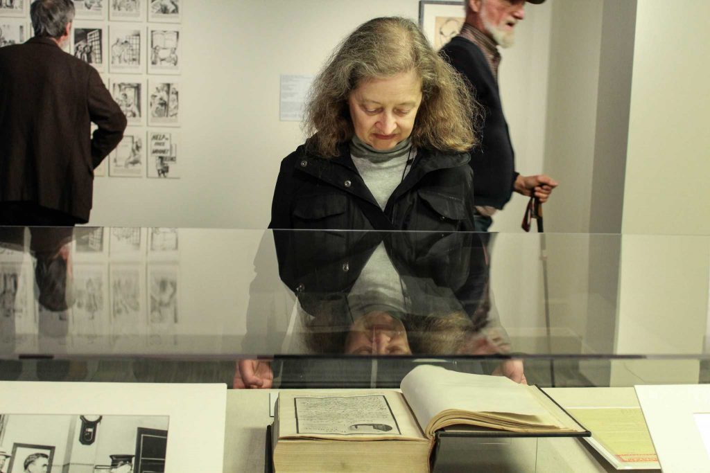 San Francisco resident Lisa Dunseth looks at a book during the exhibit of the San Francisco Preparedness Day Bombing in 1916 in the J. Paul Leonard Library on Tuesday,
Nov. 29, 2016. Photograph by: Kayleen Fonte