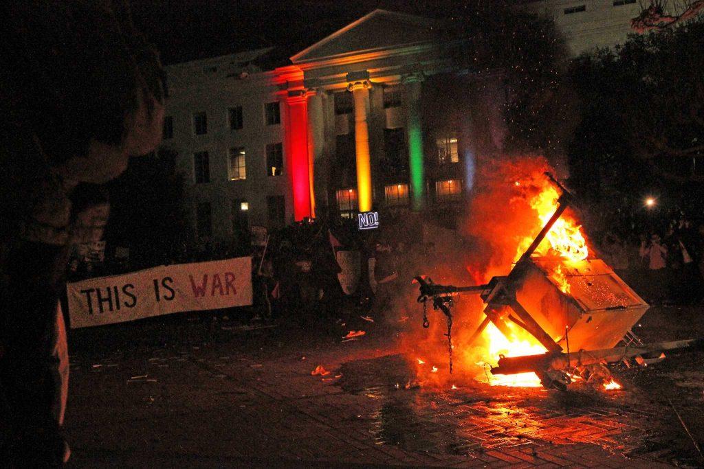 A portable light burns during a protest at UC Berkeley turned violent and shut down a scheduled speech by right-wing provocateur Milo Yiannopoulos on Wednesday, Feb. 1, 2016. (Photo by George Morin/ Special to Xpress)