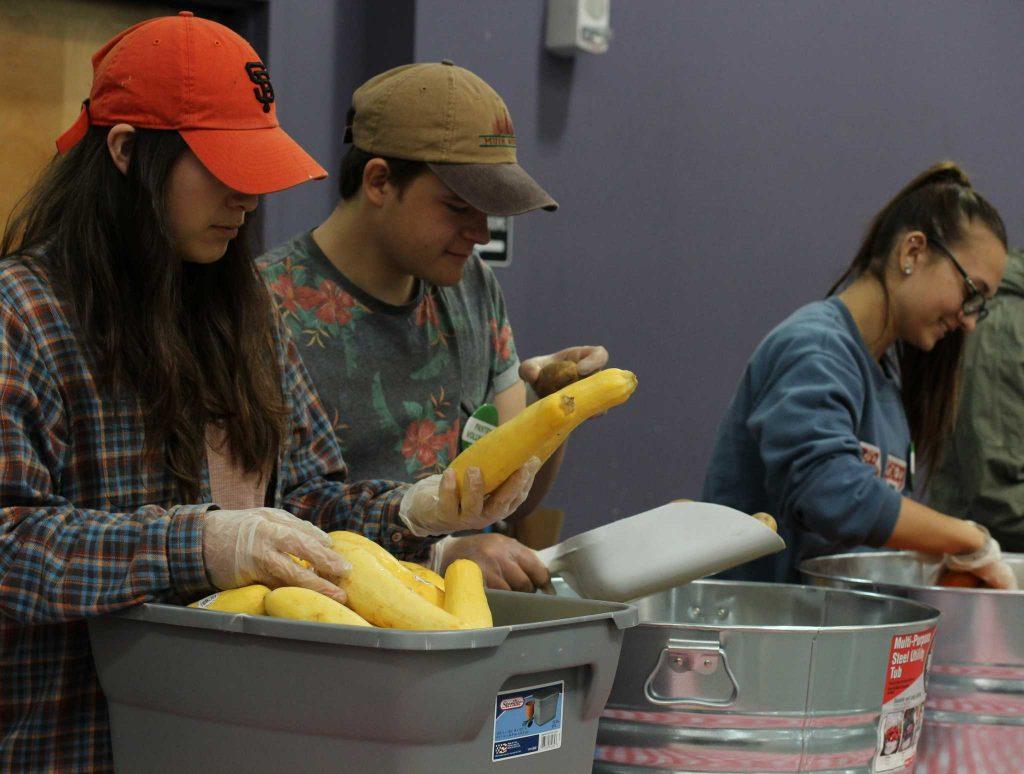 Allyson Borunda (left), Boris Ümarik (middle) and Alyssa Llewllyn (right), inspect and sort produce for the first food pantry at SF State. Associated Students Incorporated will be distributing food for students in need at the Library Annex I Student Event Center starting Monday February 27, 2017 in San Francisco, Calif. (Alina Castillo/Xpress)