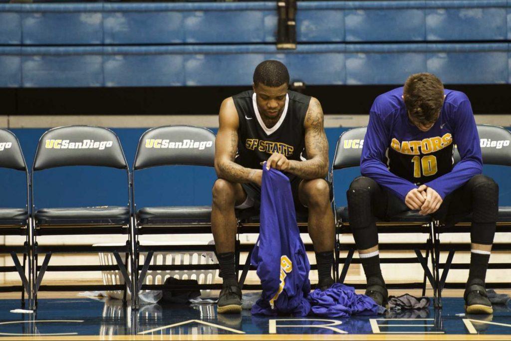 SF State Gators junior guard Warren Jackson (center) and senior guard Coley Apsay (right) look at the floor during the last minute of a NCAA playoff game against California Baptist University Lancers at RIMAC Arena in La Jolla, Calif. on Friday, March 10, 2017. The Gators lost to the Lancers with a score of 50-71. (Kin Lee/Xpress)