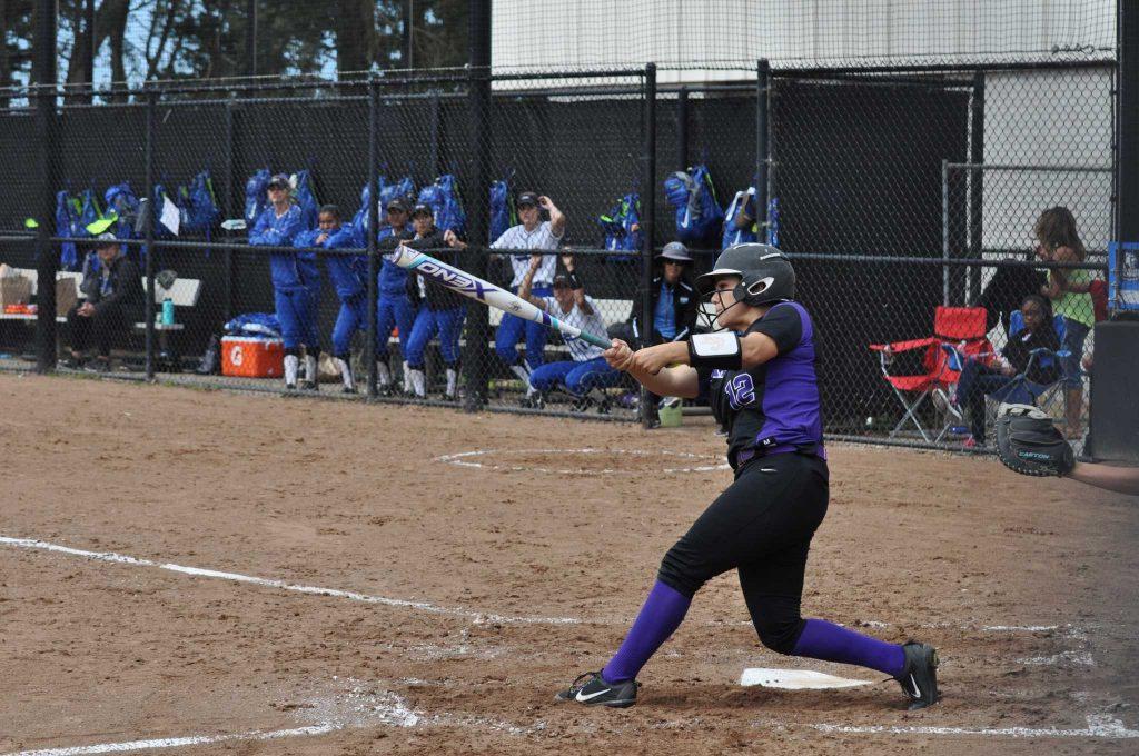 Junior catcher Celeste Adriano sends a ball into the outfield for a single against California State University San Marcos on Sat., March 12 in San Francisco, Calif. (Renee Smith/Xpress)