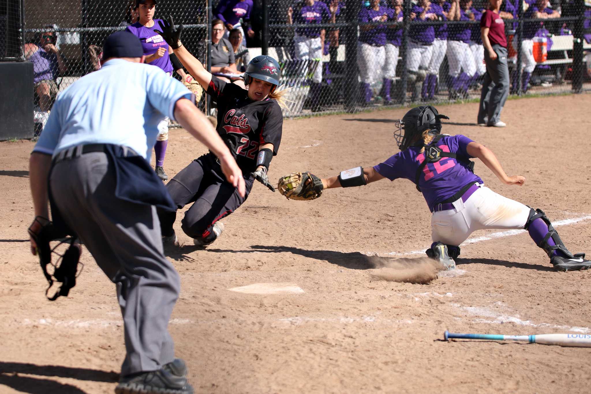 SF state Junior, C, Celeste Adriano (12), tags out Junior Chico State Wildcat, Claire Wayne (22) at home play at SF State on March. 13, 2017. (Kyler Knox/Xpress)