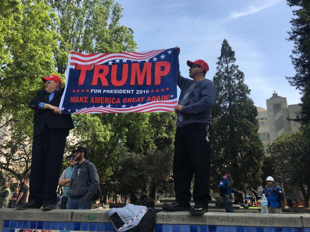 Two Trump supporters hold up a Trump for President 2016 banner during the Patriots Day Rally in Berkeley, Calif. on Saturday, April 15, 2017 (Breanna Reeves/ Xpress).