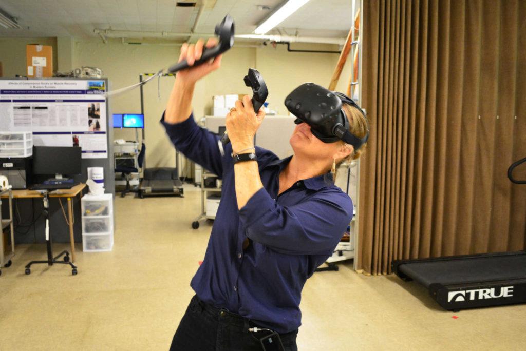 Professor Marialice Kern boxes with a virtual reality device in the Gym SF State on Monday, September 4, 2017. (Bryan Ramirez/Golden Gate Xpress)