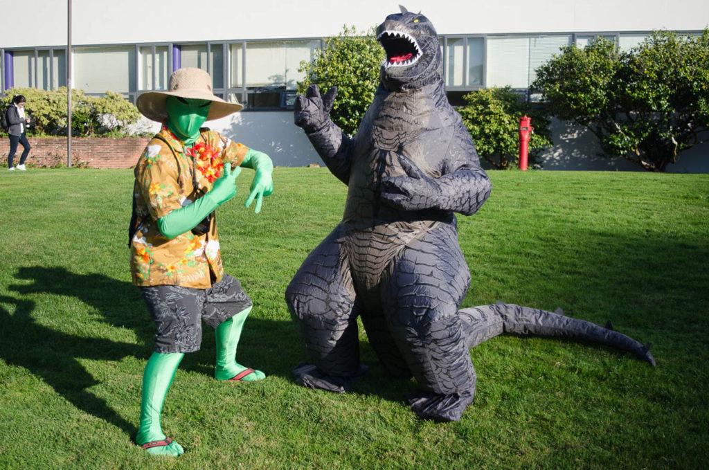 Michael Pham, 19, a biology major, is dresses as an alien tourist and Mason Hawksley, 19, a communications major, dresses as godzilla at SF State on Tuesday, October 31, 2017. (Richard Lomibao/Golden Gate Xpress)
