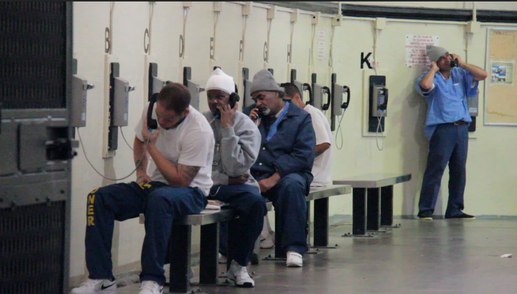 Inmates at San Quentin State Prison use the phones in West Block, a housing unit with five tiers of cells, October 10, 2016.