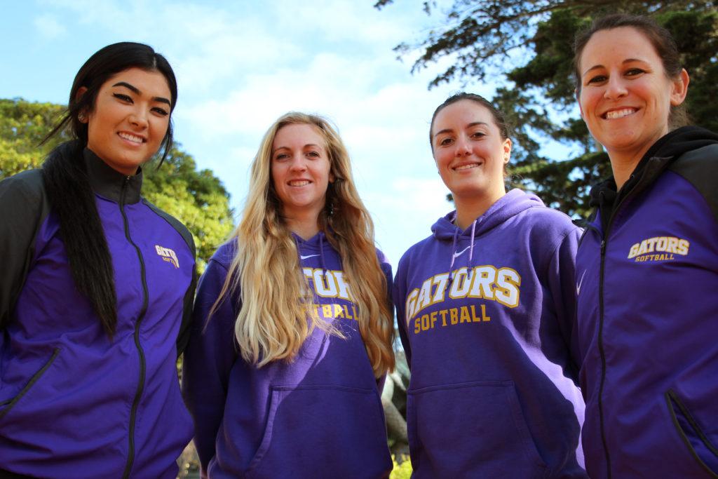 SFSU Softball third baseman Sara Higa (left), pitcher Lindsey Cassidy, outfielder Mallory Cleveland and coach Alicia Reid pose for a portrait outside the Gymnasium at SF State, Monday, Jan. 22, 2018.
 Reid was previously head softball coach at Humboldt State University for 5 years before starting this past year at SFSU and said, My philosophy of coaching is minimizing hesitation. Anticipating instead of reacting. (Christian Urrutia/Golden Gate Xpress)