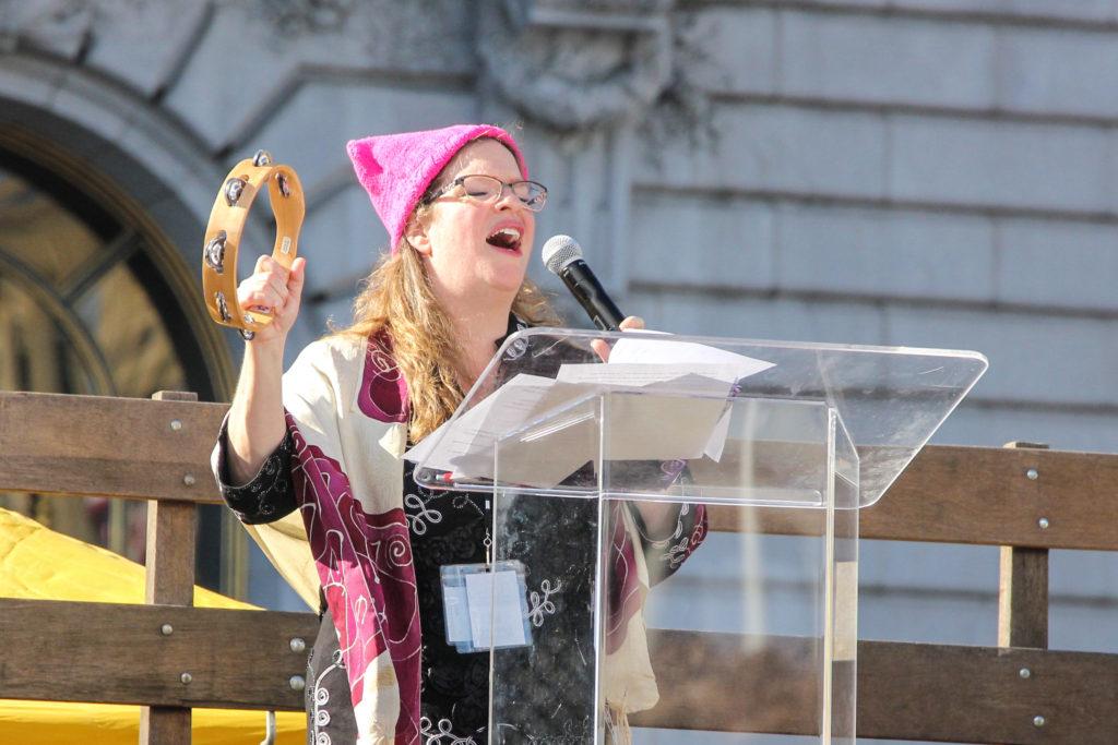 Rabbi Katie Mizrahi sings Im Gonna Let it Shine with altered lyrics towards the end of her speech outside of Civic Center Plaza during the Womens March Hear Our Voice Rally in San Francisco, Saturday, on Jan. 20, 2018. (Golden Gate Xpress/ Adelyna Tirado)