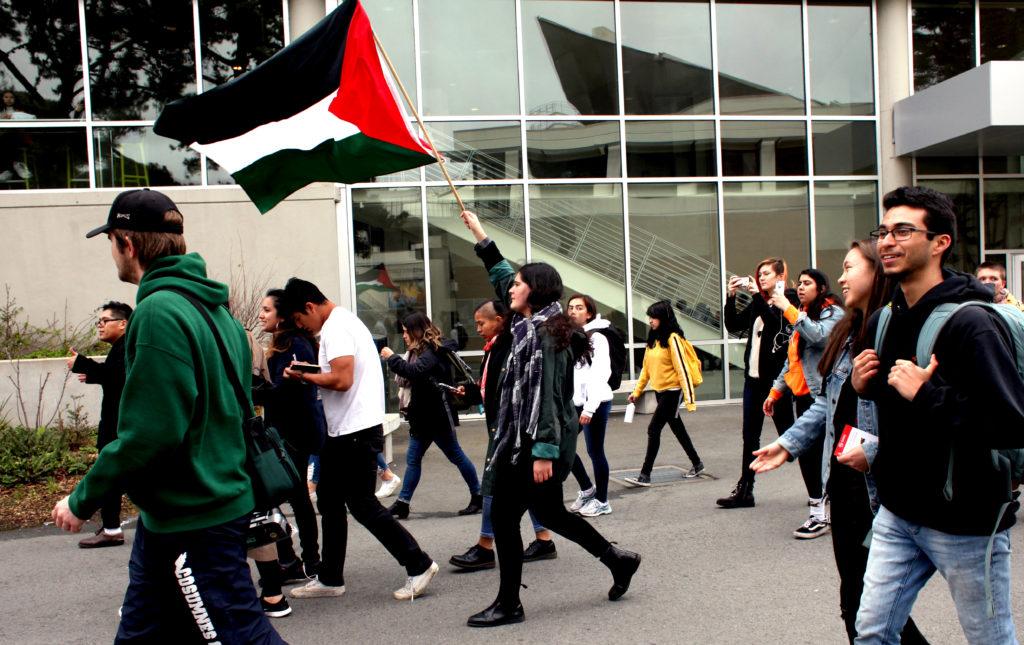A student holds the Palestinian flag while a student rally crosses the San Francisco State campus in San Francisco, Calif. on Feb. 28, 2018. (Janett Perez/Xpress)