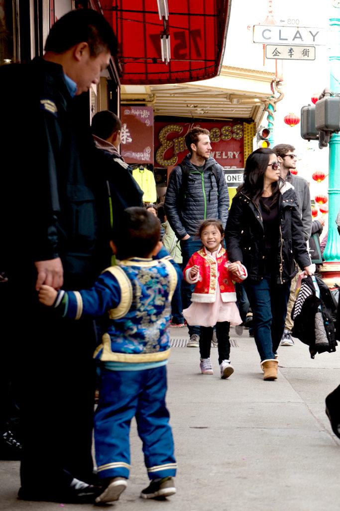 Jacob Luong, left, stands with his dad while the pair wait for the mother and daughter, Katelyn Luong, right in San Francisco’s Chinatown on Saturday Feb. 24, 2018. The two children are dressed and ready for the Chinese Lunar New Year. (David Rodriguez/Golden Gate Xpress)