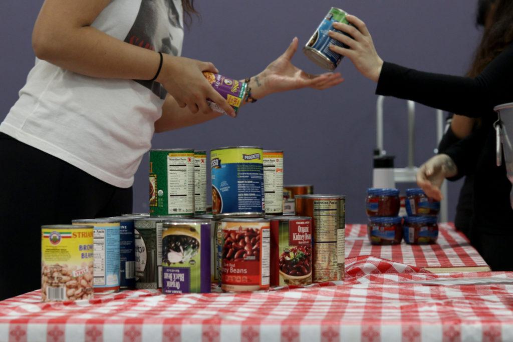 Volunteers organize cans of food at the food pantry run by Associated Students at SF State on Monday, March. 12, 2018. (Oscar Rendon/Golden Gate Xpress)