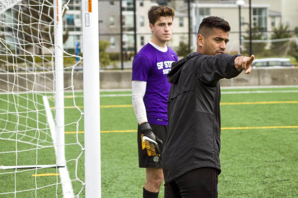 Head Coach Javier Ayala-Hil,right, works with goalkeeper Erik Ornelas, left, in between corner kicks at the Mens Soccer practice at SF State on Friday, Mar. 2, 2018. (Joey Vangsness/Golden Gate Xpress)