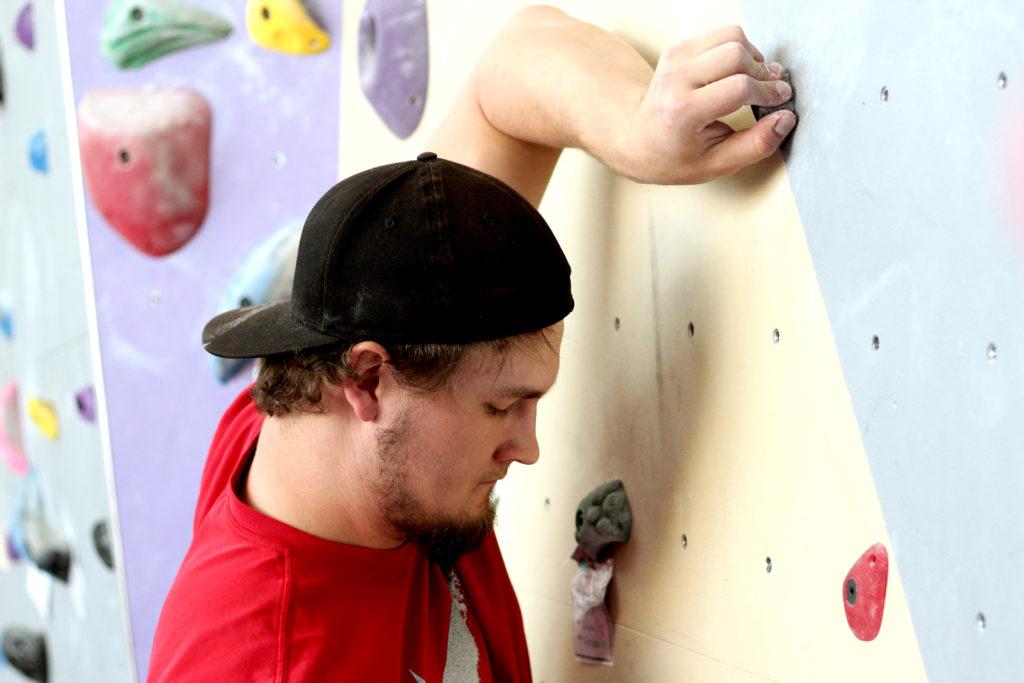 Civil engineering major Mitchell Ingles prepares to climb the rock wall in the Mashouf Wellness Center at SF State on Monday, April 9, 2018. (Christian Urrutia/Golden Gate Xpress)