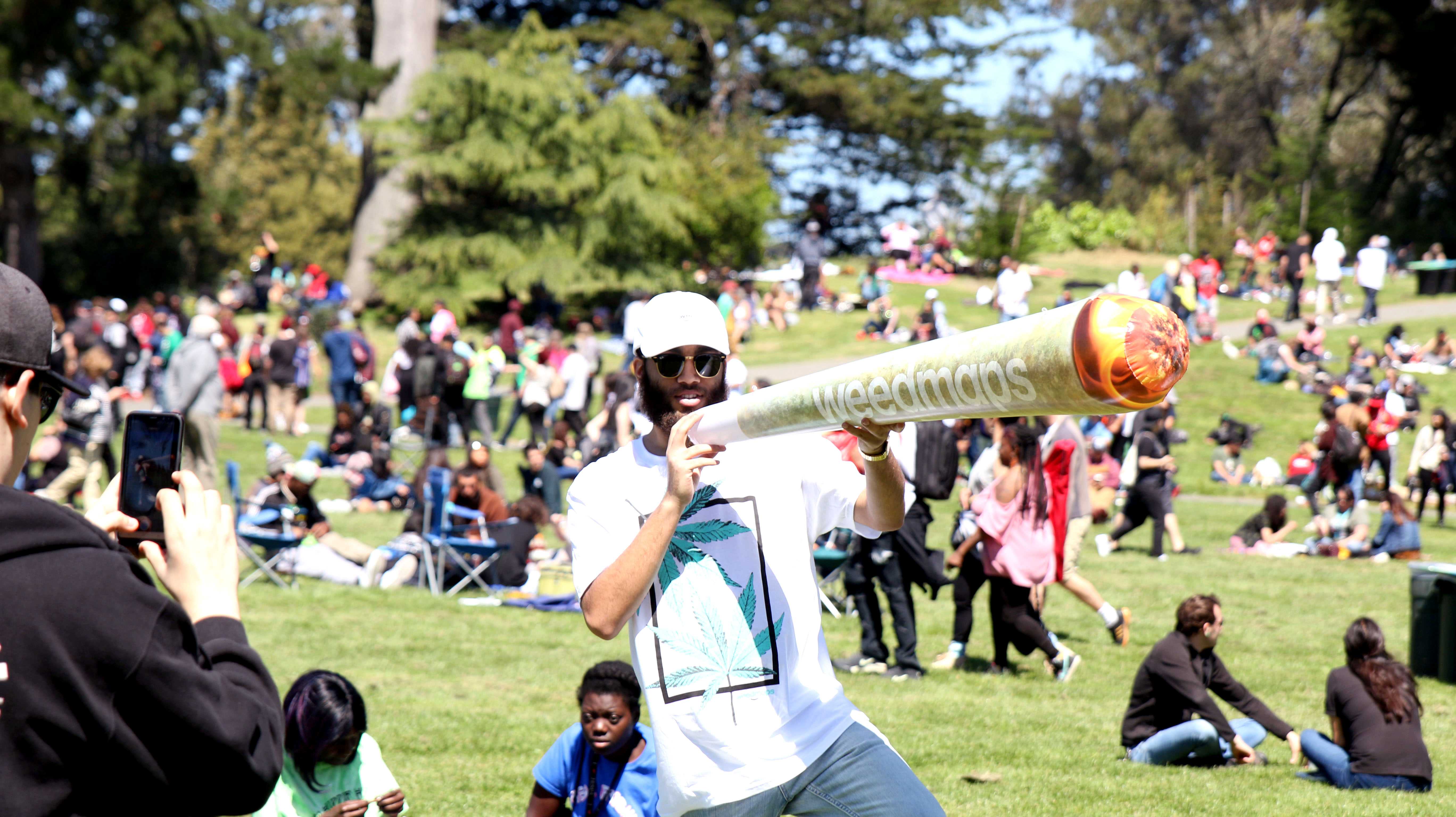 Promoter for Weed maps Chris J. blowing up a joint at the 420 event at Hippie Hill on April 20. 2018 (Golden Gate Express)