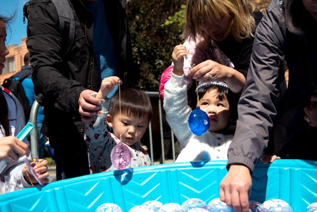 Two children whos parents chose not to disclose their names, gather around one of the many inventive games at that are available for children at the 2018 Cherry Blossom Festival in San Francisco on Saturday, Apr. 15, 2010. (David Rodriguez/Golden Gate Xpress)