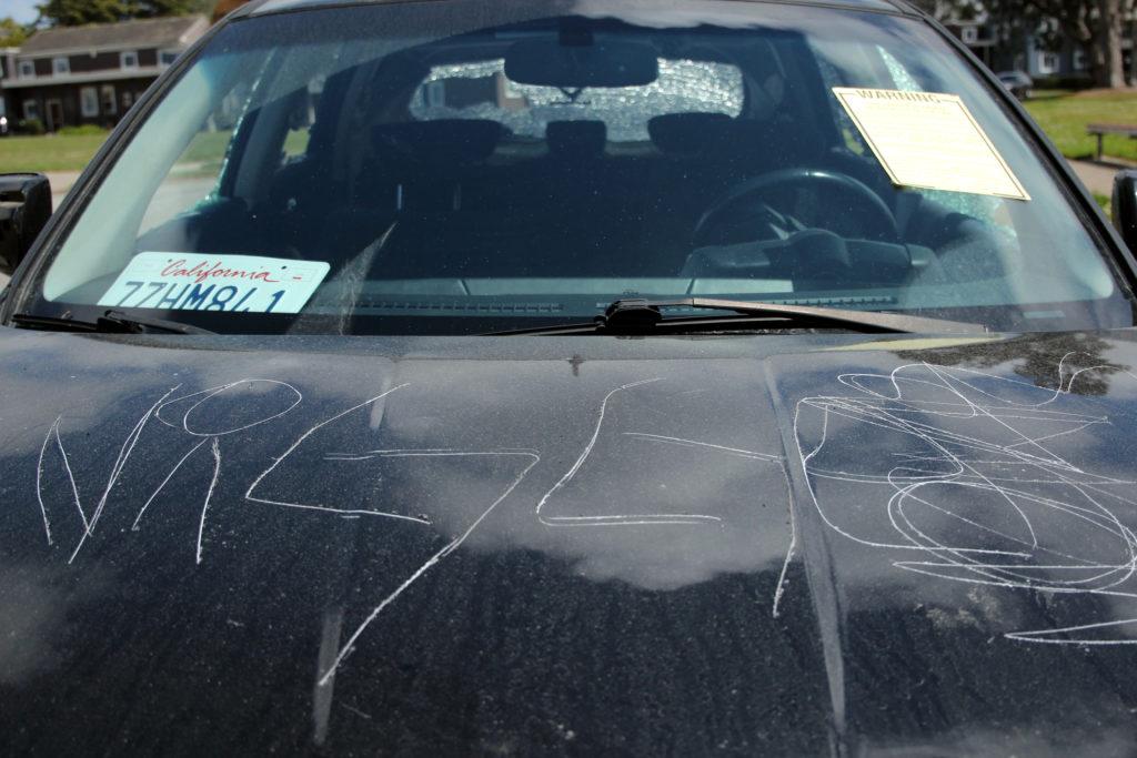A car is seen as it was vandalized at Juan Bautista Circle near Fuente Avenue in the Parkmerced neighborhood close to SF State on Wednesday, May 16, 2018. The act of destruction seems to be racially motivated.  (Christian Urrutia/ Golden Gate Xpress)