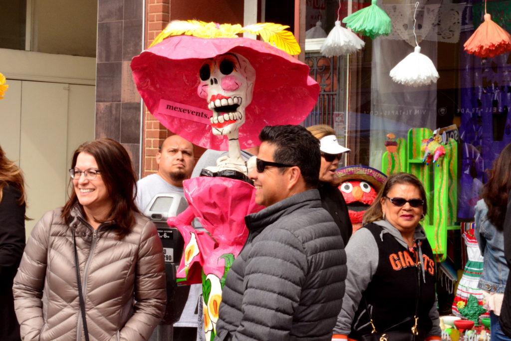 Attendees gathering around a monument often referred to as La Muerte during the the Cinco De Mayo Fair located on Valencia Street of San Francisco on Saturday, May 5, 2018. (Bryan Ramirez/Golden Gate Xpress)