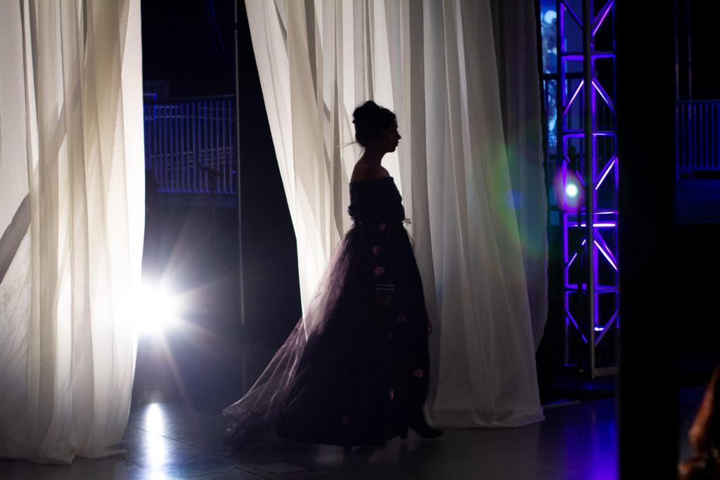A model emerges from backstage to begin the walk down the runway during Runway 2018: Diverge on Thursday, May 2018.