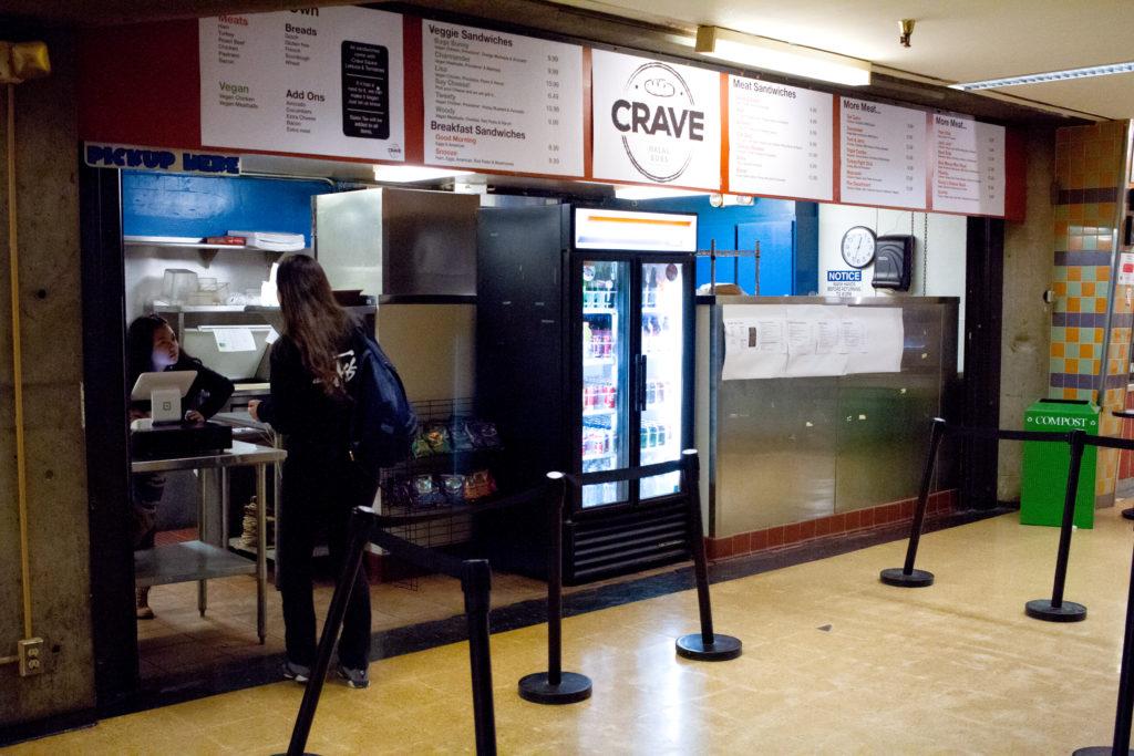 A student places an order at Crave Halal Sandwiches in the basement of the Cesar Chavez building on Monday, Apr. 30, 2018.