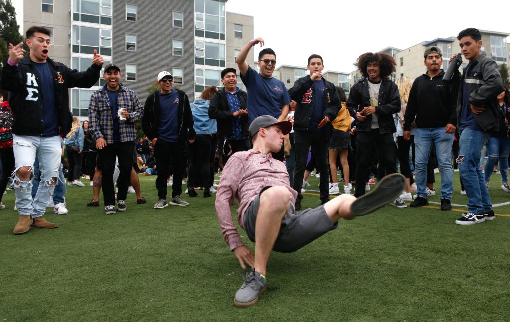 Incoming freshman Lucas Sherrill begins breakdancing as fellow students cheer him on during the Student Life Carnival event at SF States West Campus Green field on the second night of Gatorfest on Saturday, August 25, 2018. (Niko LaBarbera/Golden Gate Xpress)