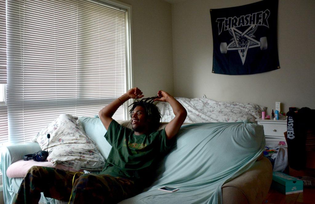 Poohrail sits in his home in Park Merced, as he describes his life leading up to his professional career and starting his line of skateboards named Create Skateboards on Friday, Sept. 21. (Tristen Rowean/Golden Gate Xpress)