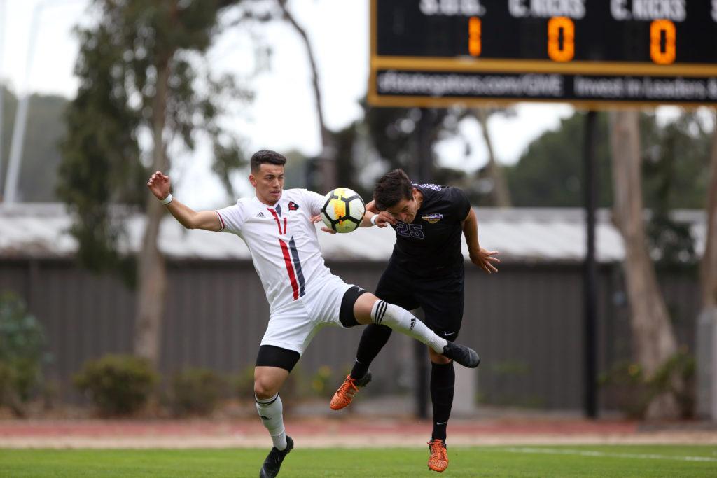 SF State defender Miles Burditt (25) jumps up to head the ball away from an opposing player during the mens soccer game against Holy Names University at Cox Stadium in San Francisco, Calif. on Thursday, Sept. 6, 2018. The game ended in a 1-1 draw. (Mira Laing/Golden Gate Xpress) 