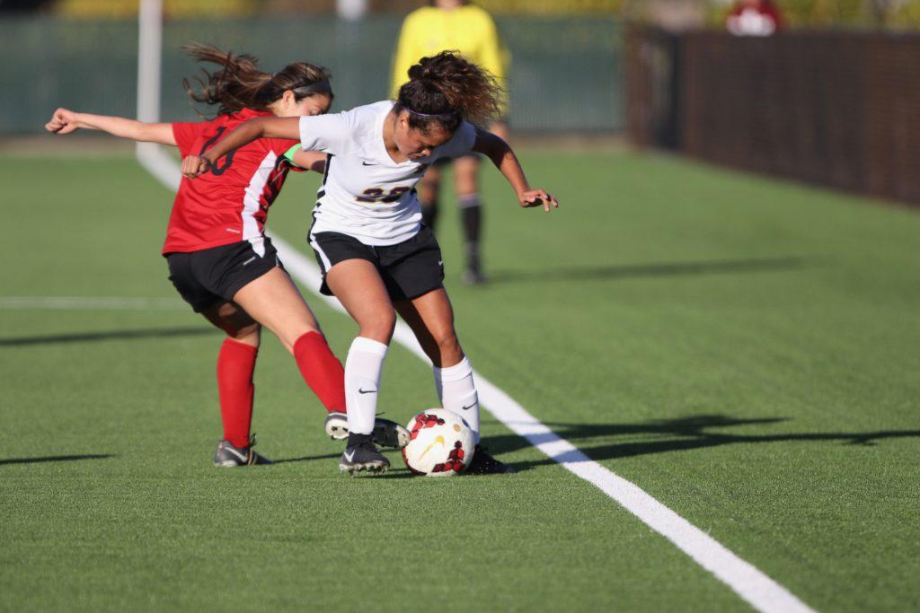 SF State center forward Karla Ramos (26) battles for the ball against Holy Names University Hawks at the Skyline soccer field in San Bruno on Sept. 19, 2018. (Oscar Rendon/Golden Gate Xpress)